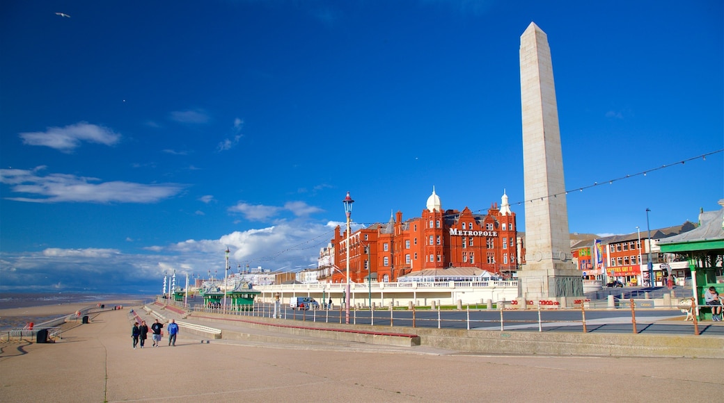 Blackpool North Shore Beach featuring a monument as well as a small group of people