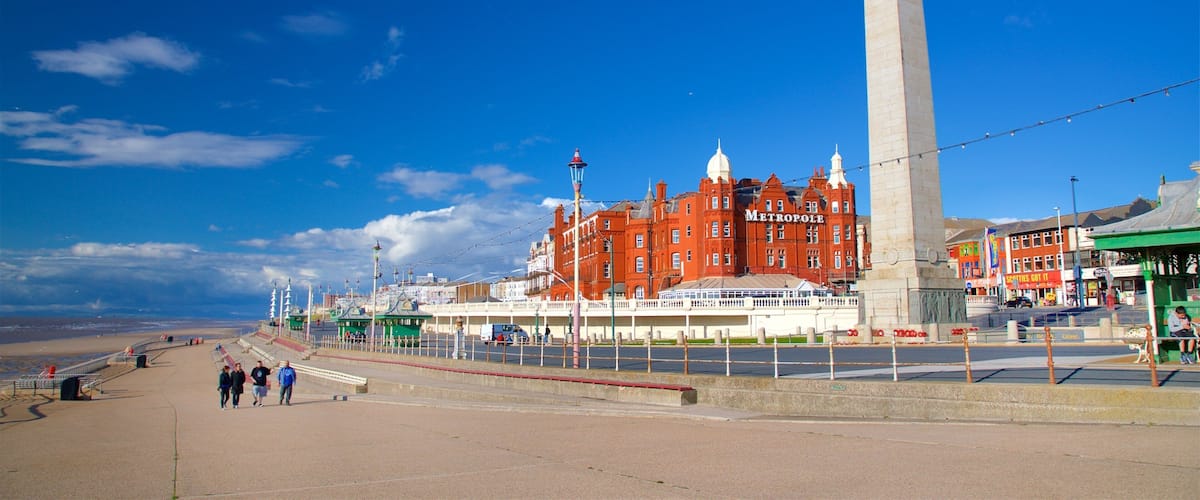 Blackpool North Shore Beach featuring a monument as well as a small group of people