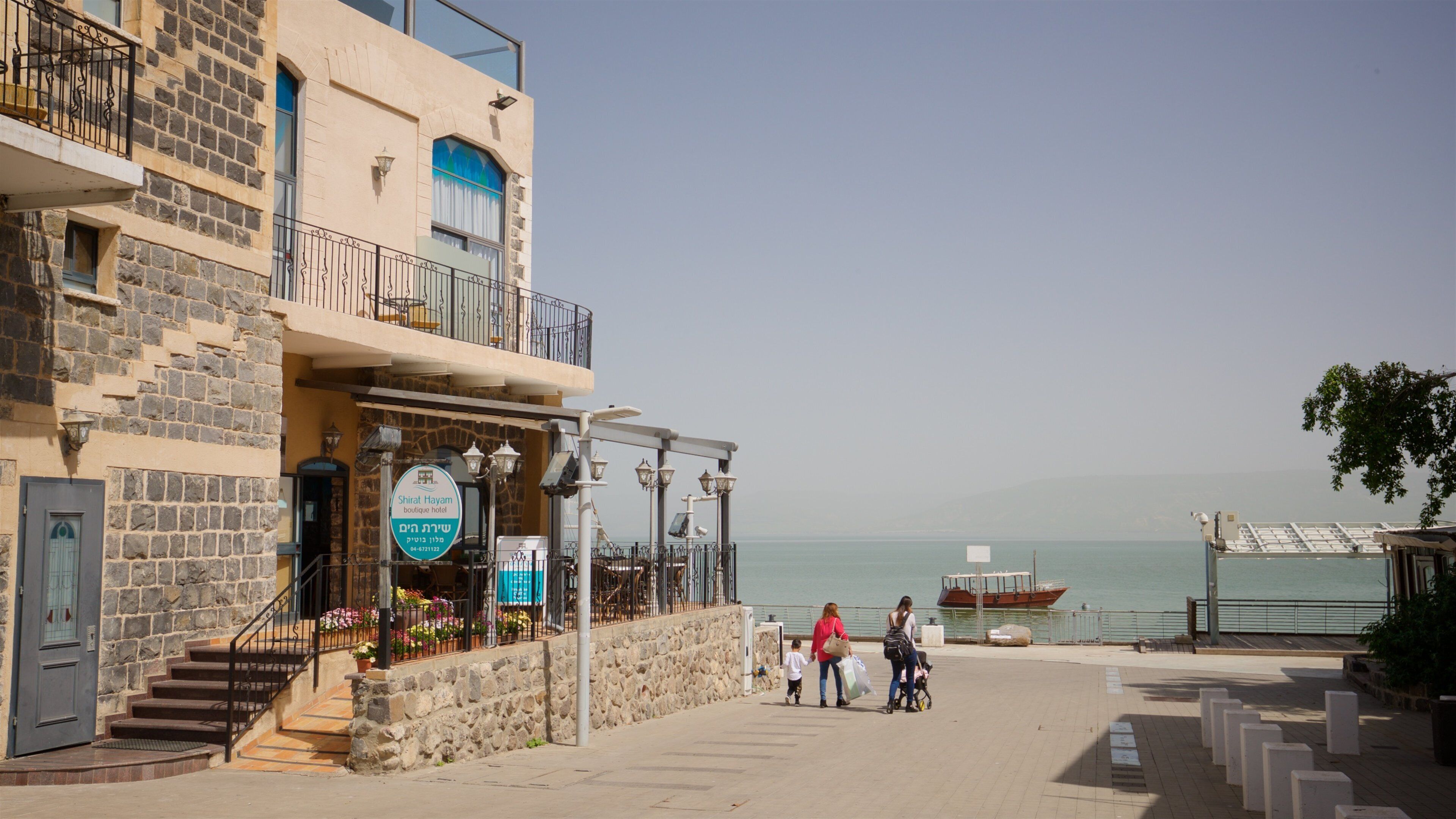 Tiberias Marina showing a coastal town as well as a family