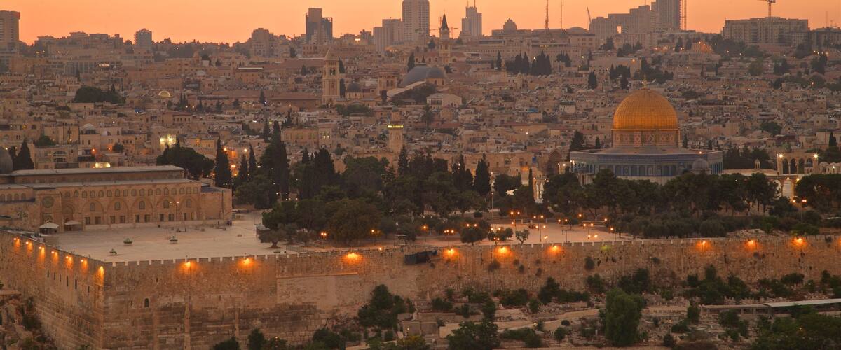 The Dome of the Rock, the Western Wall, and the Old City of Jerusalem at sunset.