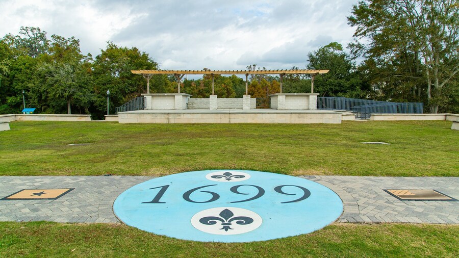 Fort Maurepas Park featuring signage and a garden