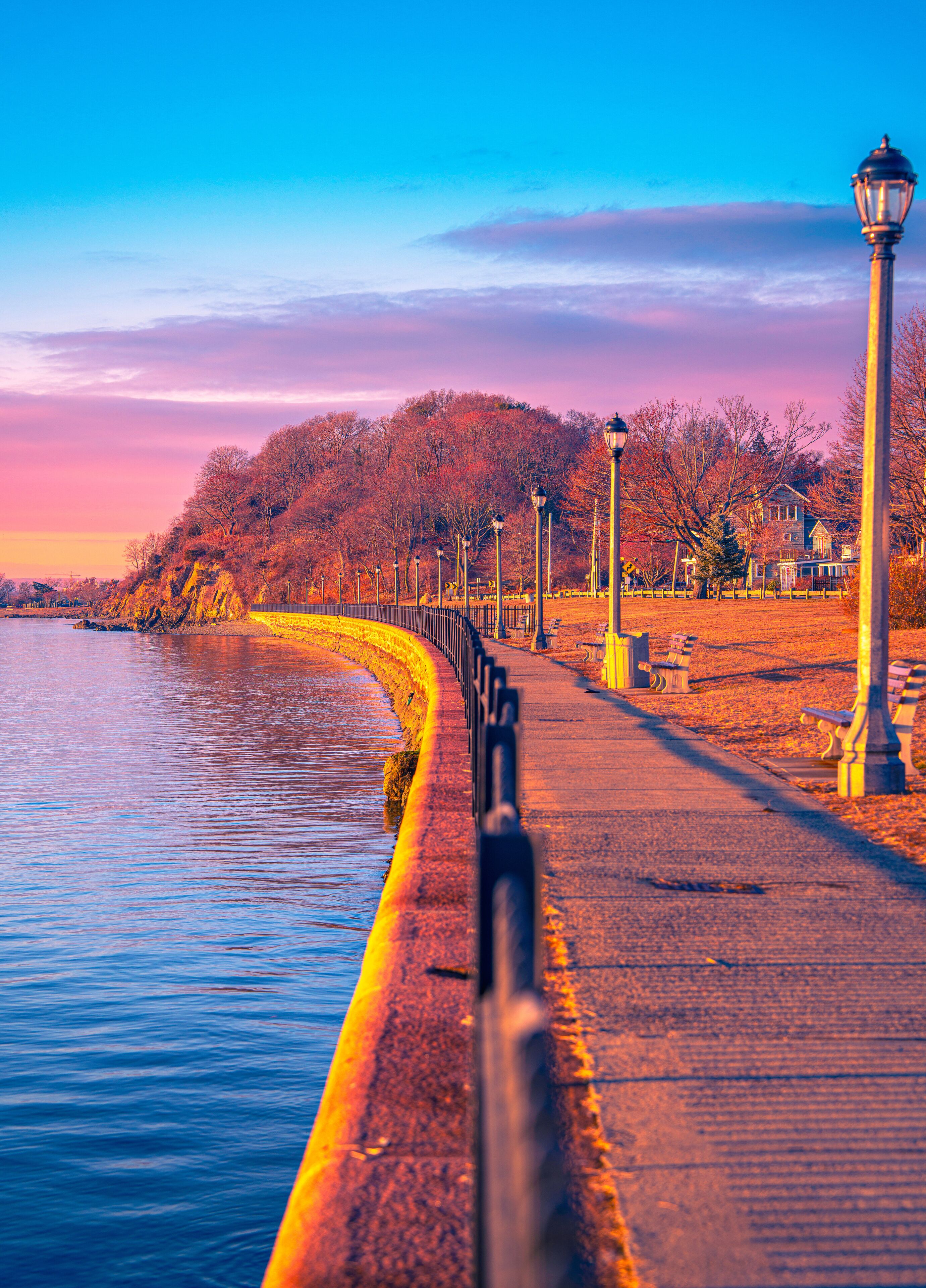 New England Seascape in New Haven Harbor in Connecticut at Sunrise: A tranquil beachfront along the Pardee Seawall Park