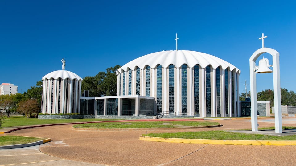A modern church with two large domes and a bell tower.