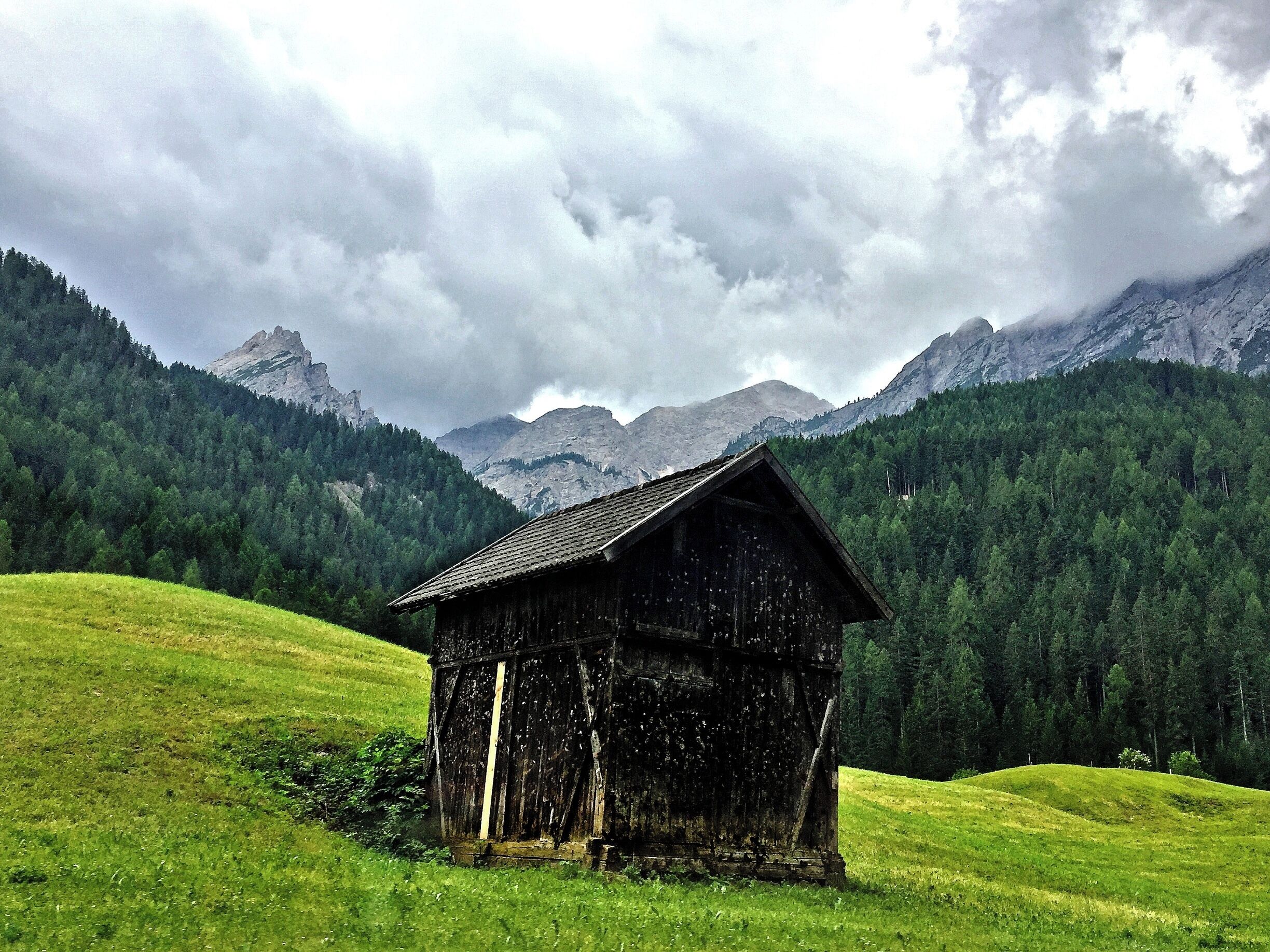 Along the way from Villabasa to Lago Braies, is a teasing scenery of attention-grabbing mountains and greens.  The weather was a bit rainy when I went but it created a mystic feeling of awe.   I took this photo from the moving bus.  The hut was an appealing accent to the magnificent nature.

If this hut/cabin would be sold for 200Euro, including taxes, I'd buy and live with no complaint in this (barely) 5sqr foot property!!  I wonder where to poop...?

#tinyhomes