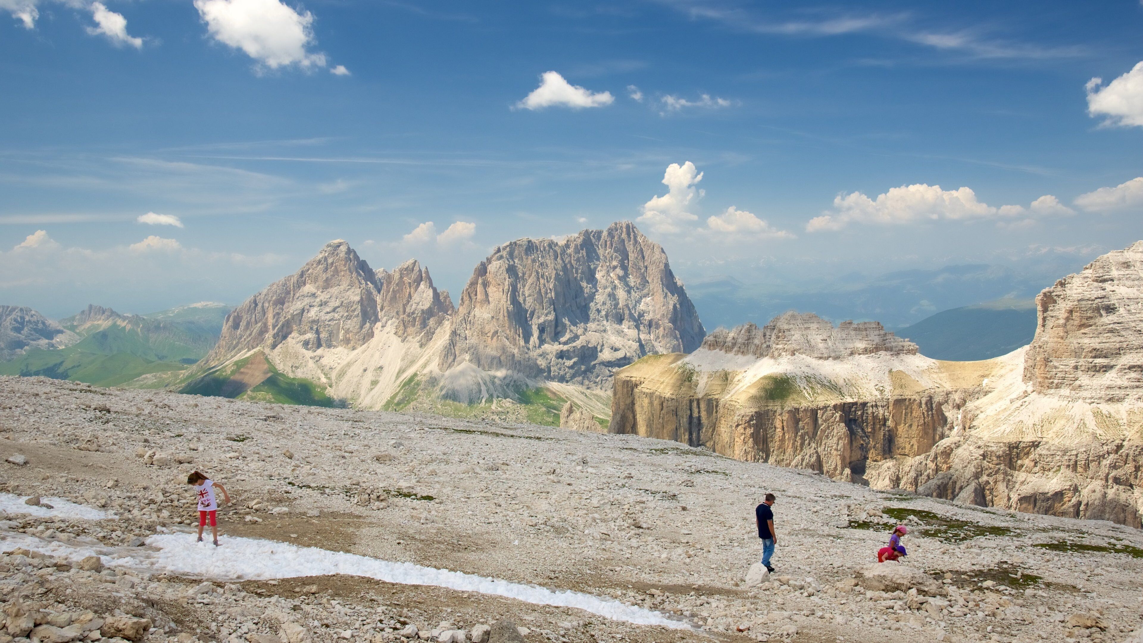 Trentino featuring mountains and hiking or walking as well as a small group of people