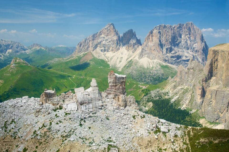 A rugged mountain landscape with rocky outcrops and a clear sky.