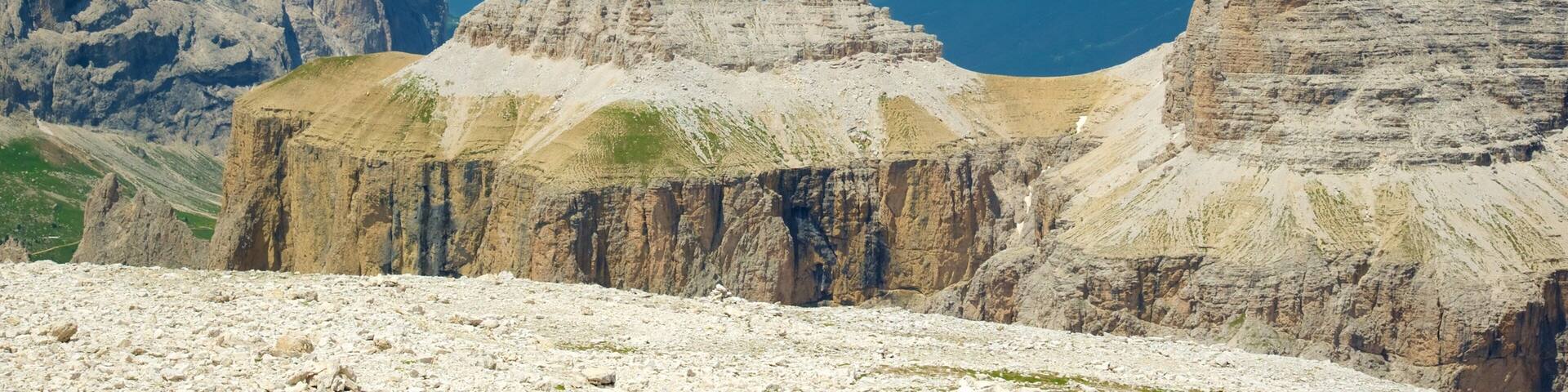 A mountainous landscape with rocky formations and a clear blue sky.