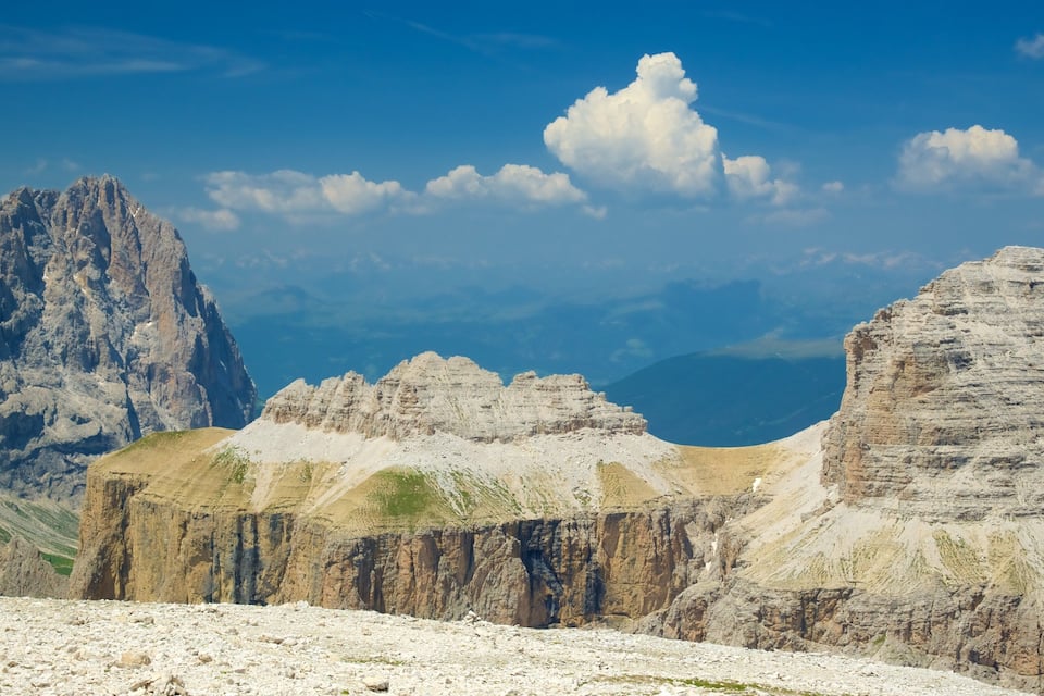 A mountainous landscape with rocky formations and a clear blue sky.