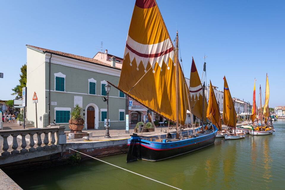 Un canale con barche e palazzi lungo il lungomare.