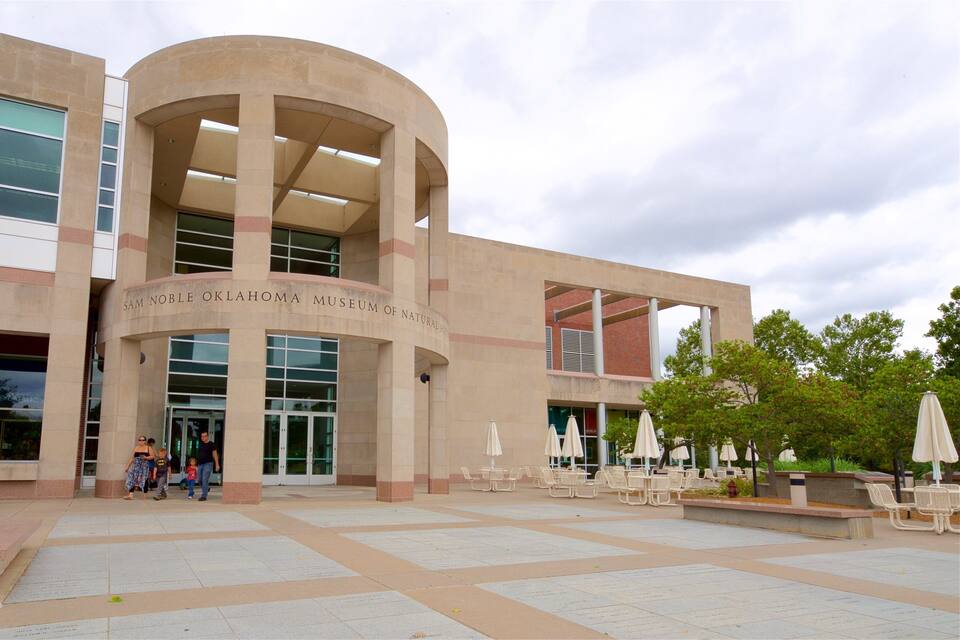 The Sam Noble Oklahoma Museum of Natural History building with a curved entrance and outdoor seating area.