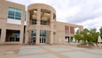 The Sam Noble Oklahoma Museum of Natural History building with a curved entrance and outdoor seating area.