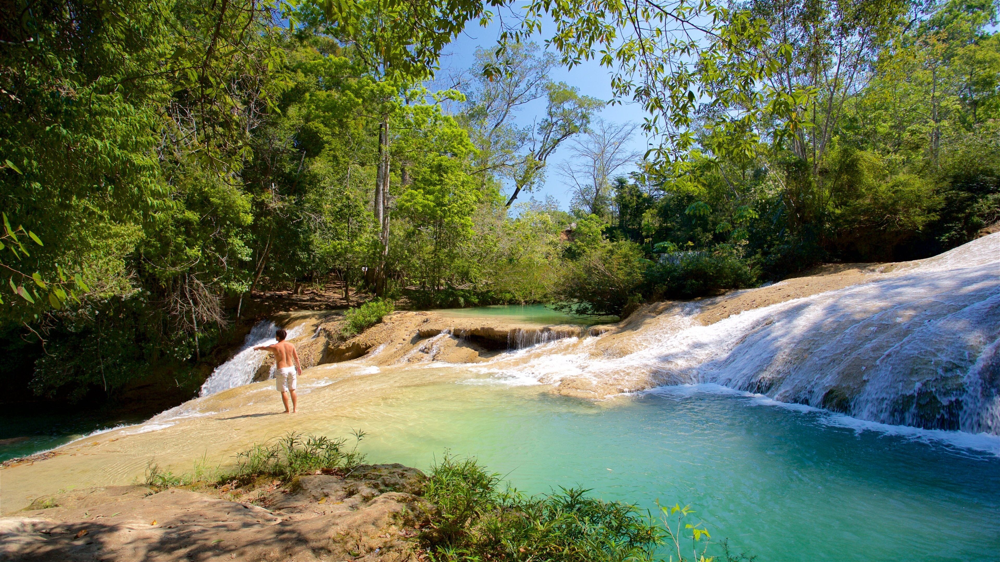 Cascada de Roberto Barrios featuring a river or creek as well as an individual male