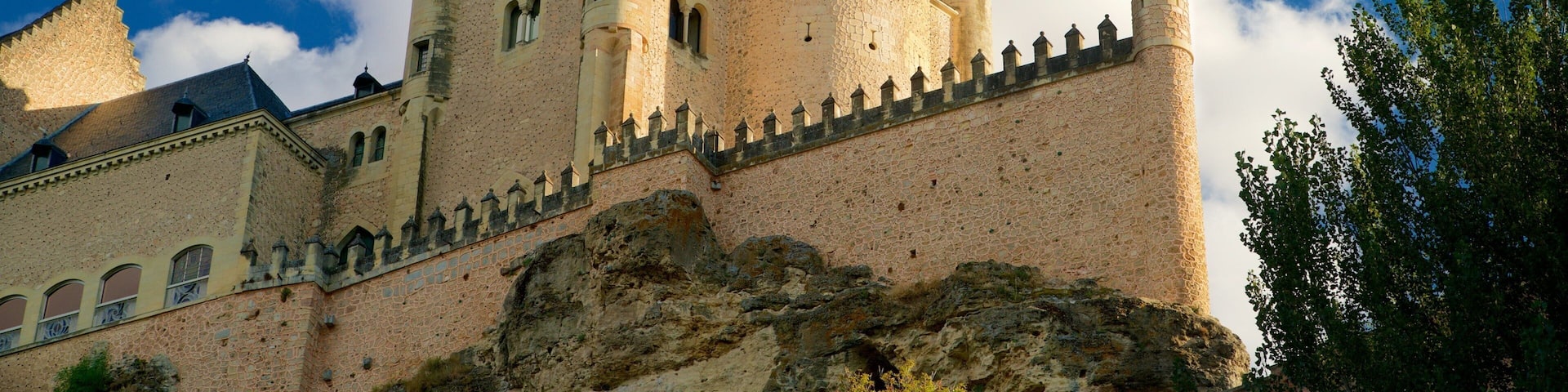 A castle with multiple towers and a stone wall.