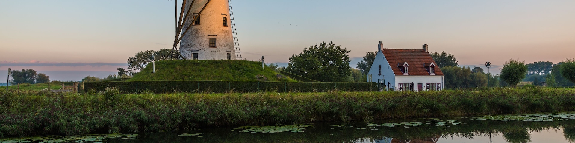 Sunrise light over a windmill in Damme, Belgium