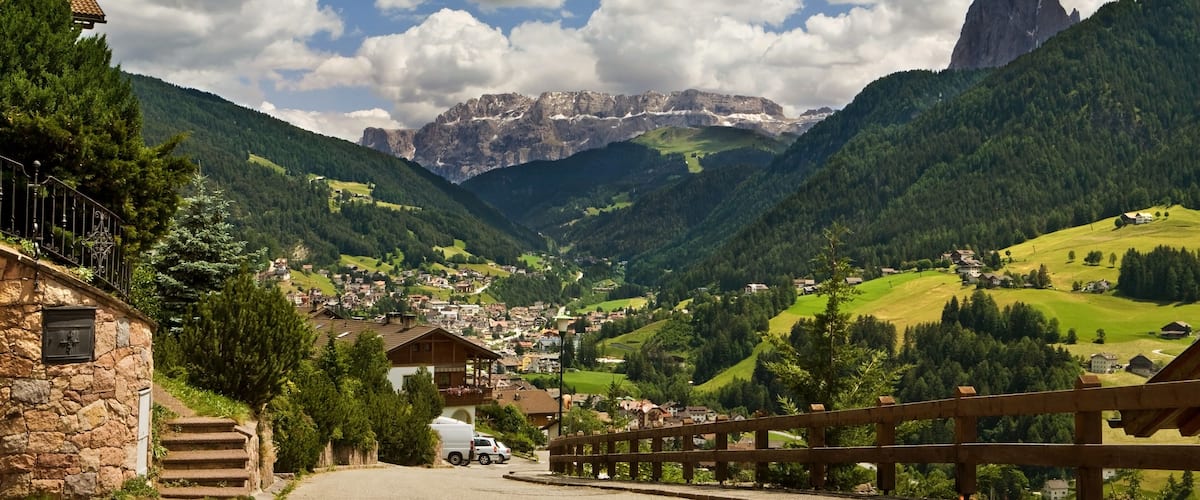 Ortisei, Italy. Kind on a city from above and a kind on dolomites mountains