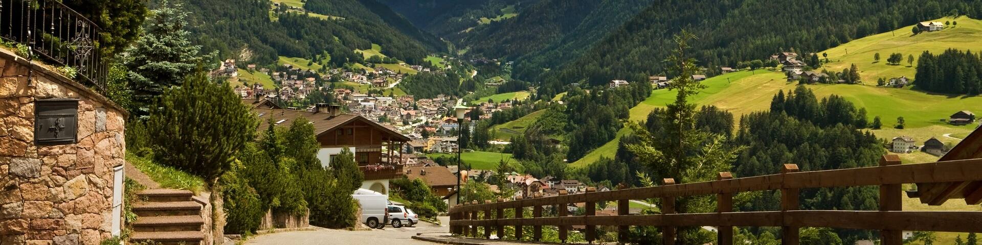 Ortisei, Italy. Kind on a city from above and a kind on dolomites mountains