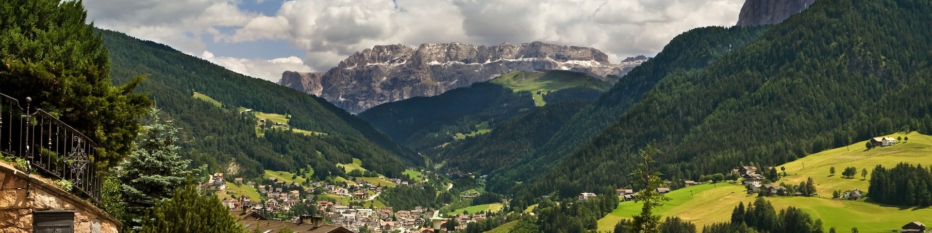 Ortisei, Italy. Kind on a city from above and a kind on dolomites mountains