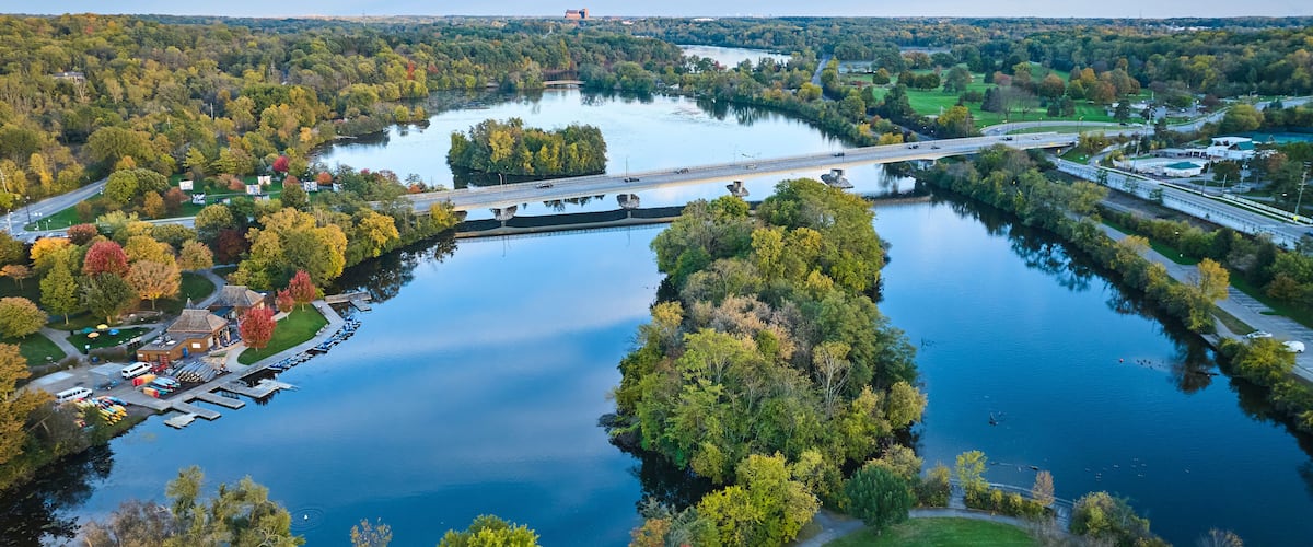 Aerial Autumn Riverside with Bridge and Marina in Michigan