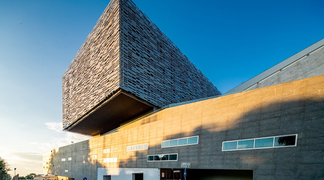 Arcetri which includes modern architecture and a sunset