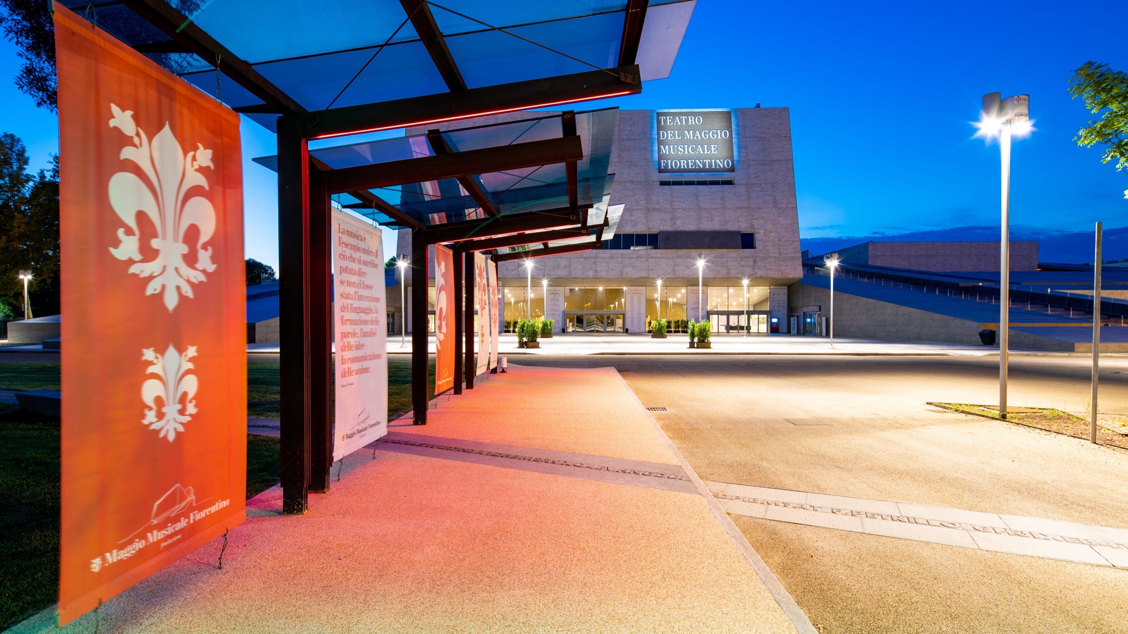 Teatro Del Maggio Musicale Firenze entrance with a modern glass structure and illuminated signage.