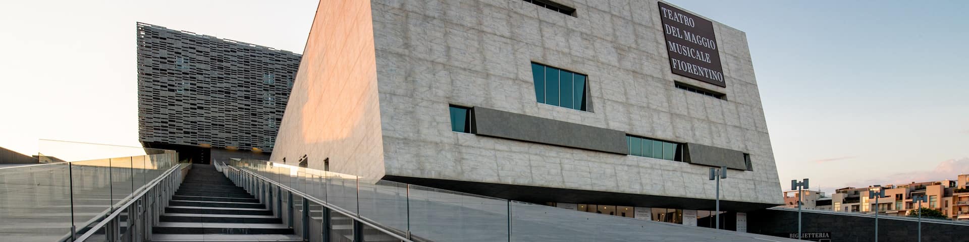 A modern building with a large sign reading "Teatro del Maggio Musicale Fiorentino".