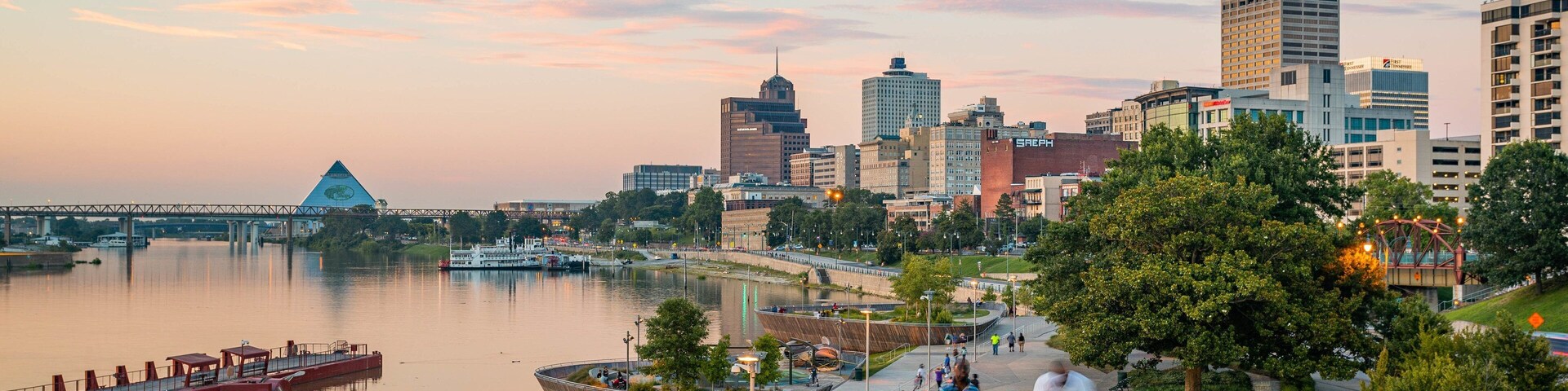Beale Street Landing showing a city, a park and a sunset