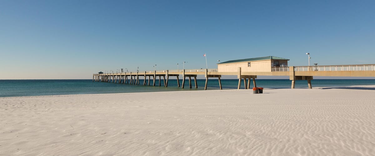 FXKH87 Okaloosa Island Pier along an empty beach in Fort Walton Beach, Florida.