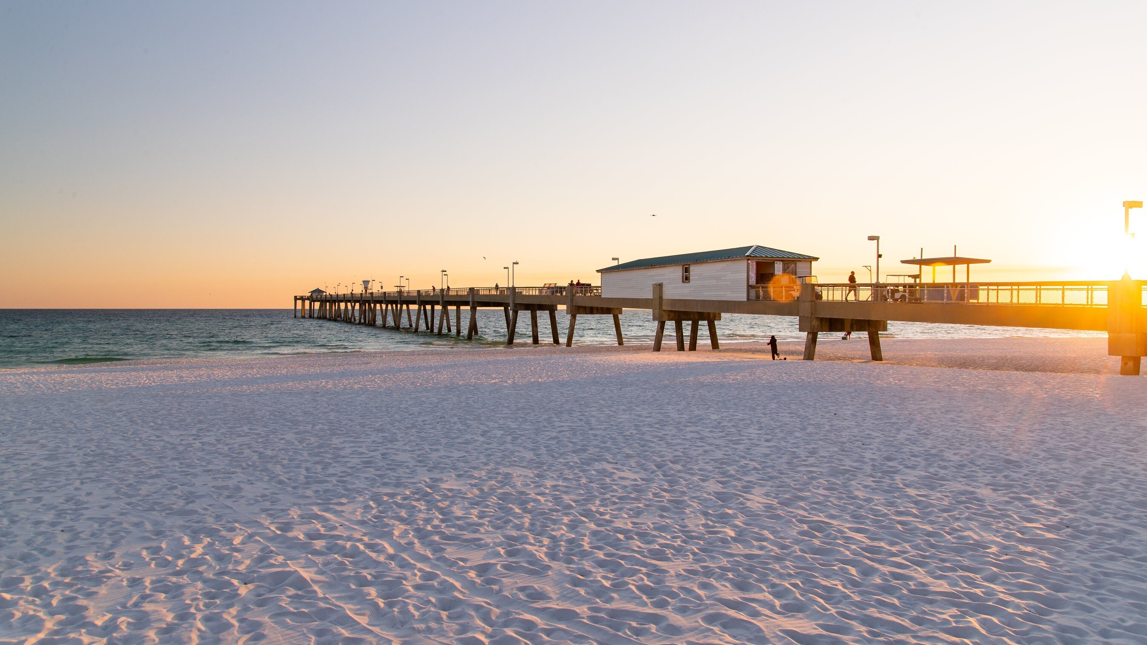 Okaloosa Island Pier featuring a beach, general coastal views and a sunset