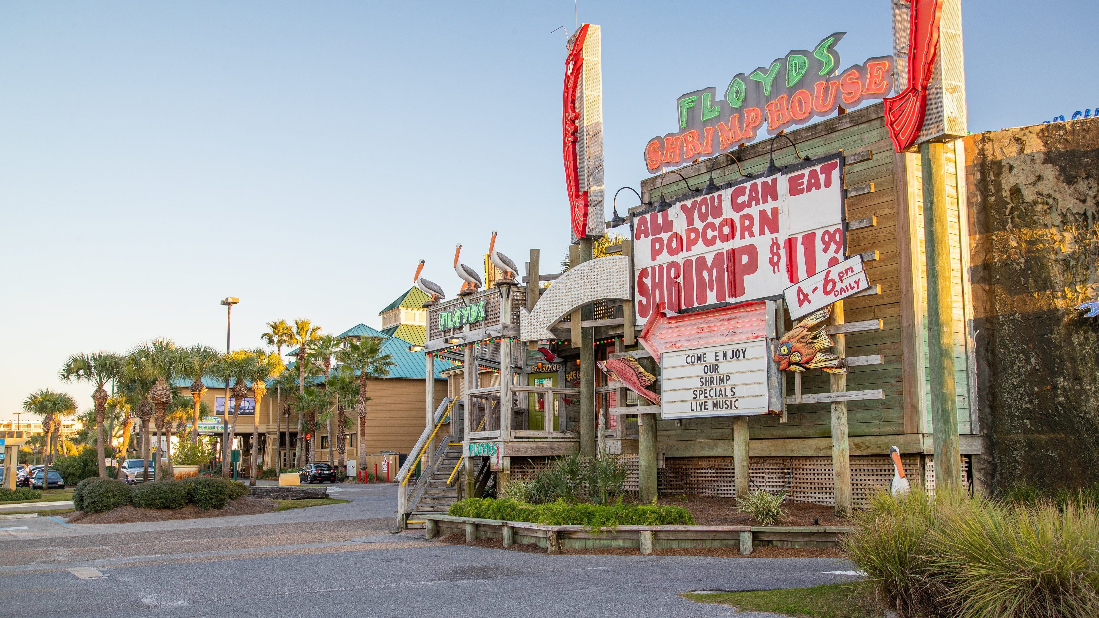 Okaloosa Island Pier which includes a sunset and signage
