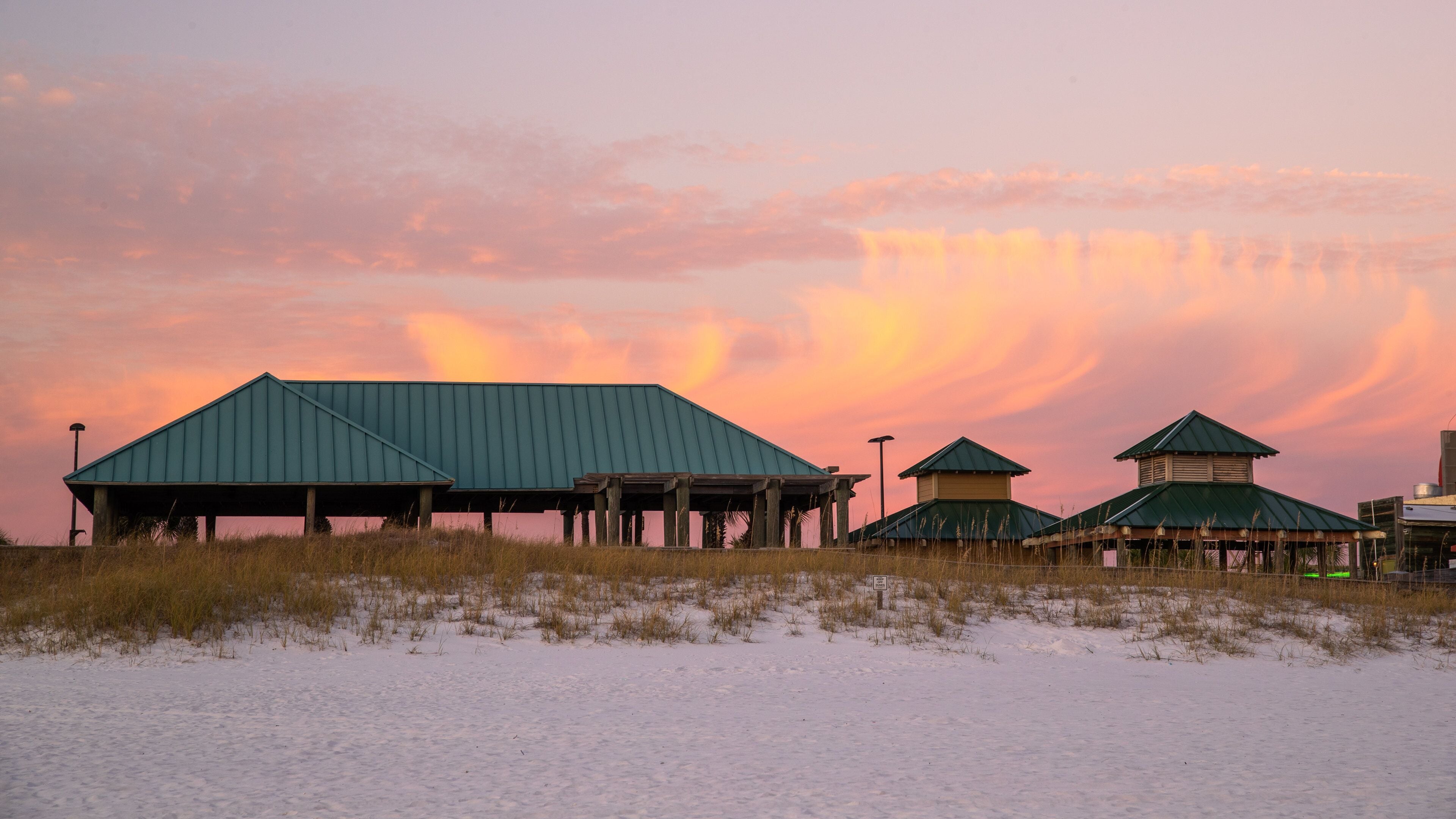 Okaloosa Island Pier which includes a beach and a sunset
