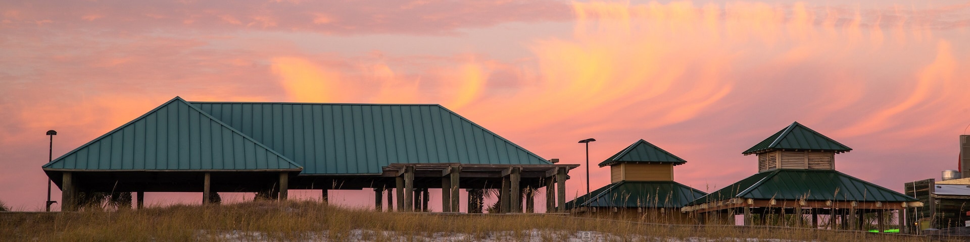 Okaloosa Island Pier which includes a beach and a sunset