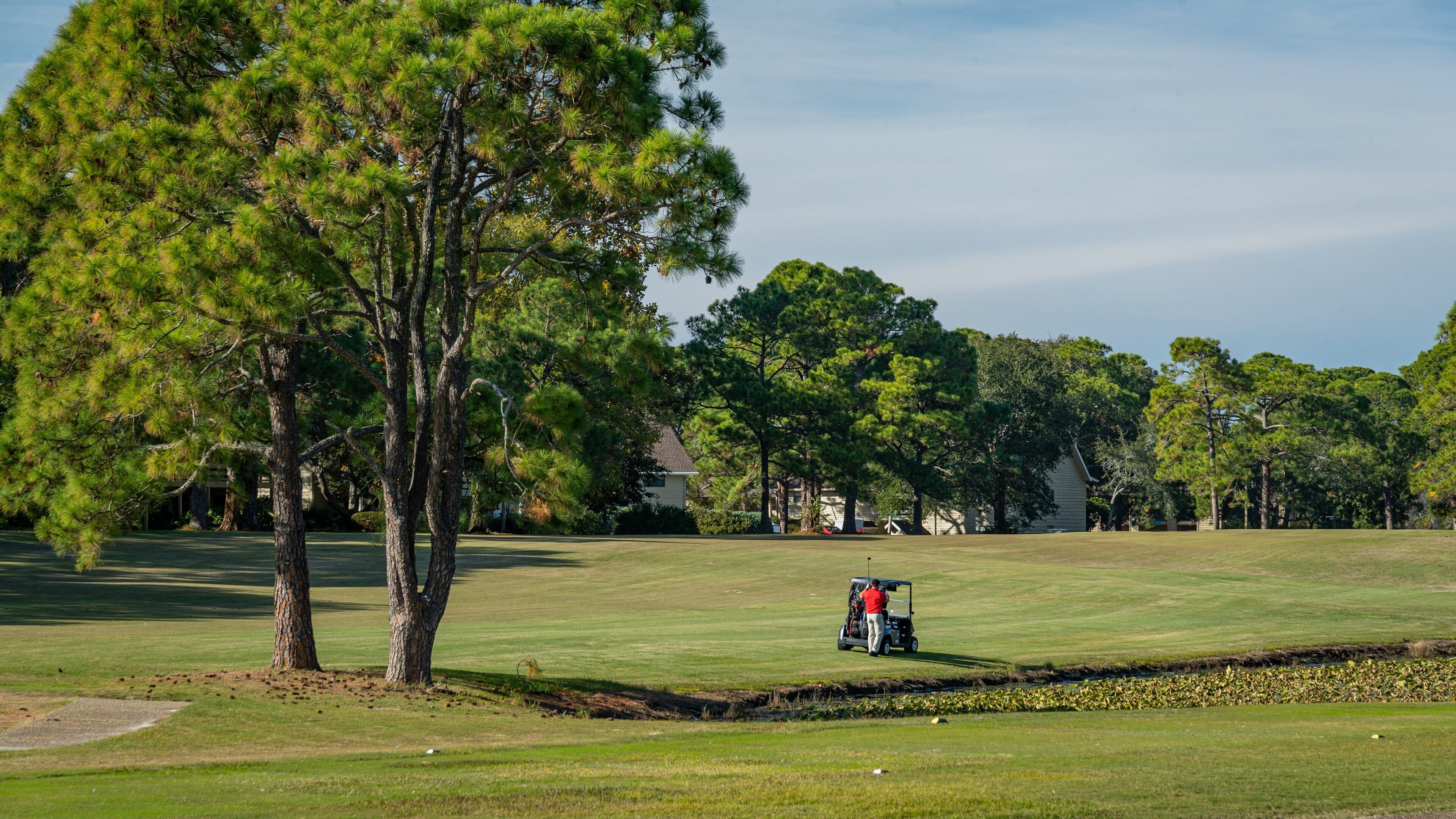 Golf Course At Seascape Resort which includes golf as well as an individual male