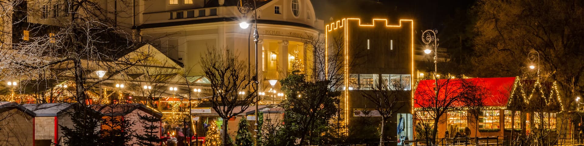 Meran Merano in South Tyrol, Italy, during the Christmas with christmans market by night . Beautiful light and great atmosphere