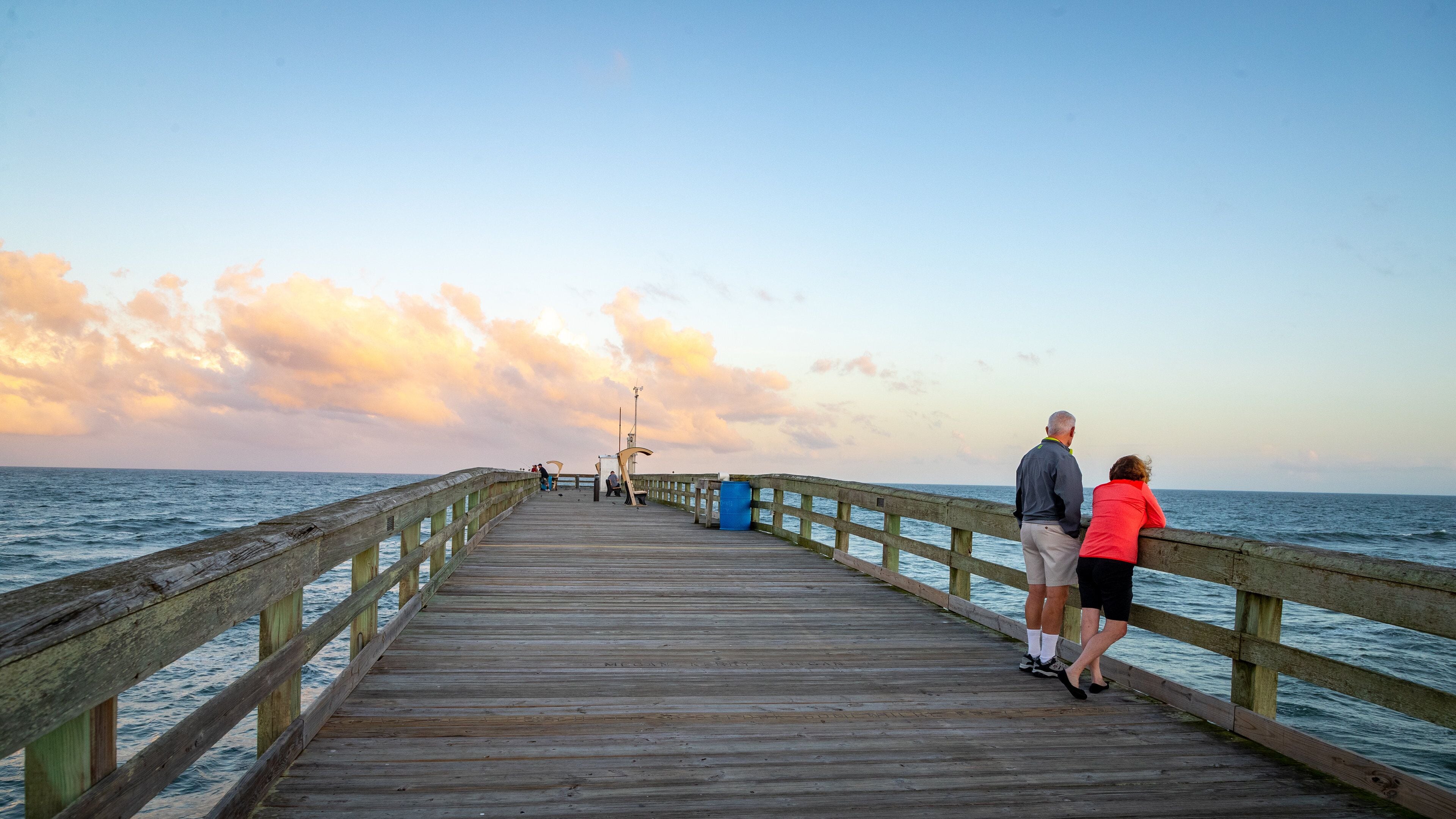 St. Johns County Ocean Pier featuring a sunset and general coastal views as well as a couple