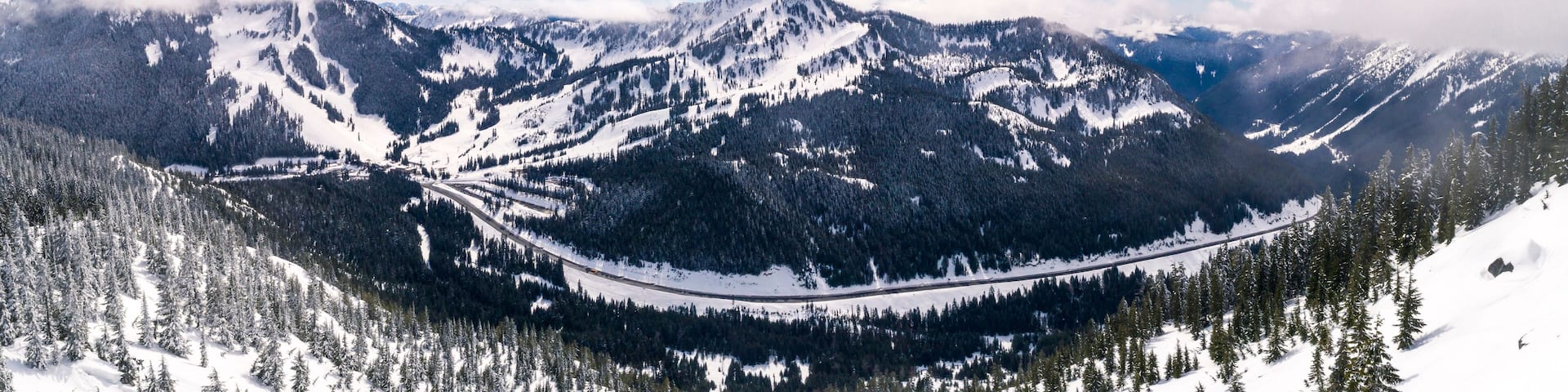 Panorama of Snowy Mountain Road and Winter Sports Resort in Pacific Northwest Forest