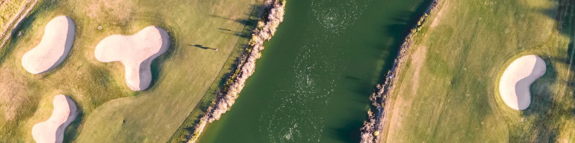 Aerial view of the golf court with a small lake in the field, view of the country sport club in Cruz Quebrada-Dafundo, Lisbon, Portugal.