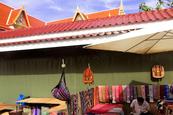 WAT KARON MARKET, KARON, PHUKET, THAILAND FEBRUARY 16 2013: Vendor has snack market stall under temple building