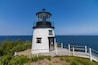 Owls Head Lighthouse in Rockland Maine USA on a clear sunny summer day with blue sky