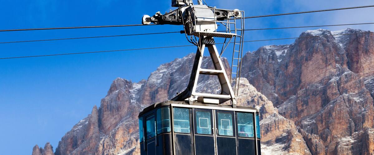CORTINA D'AMPEZZO, DOLOMITES, The cable car on the background of rocks, Veneto, Italy. Winter view.