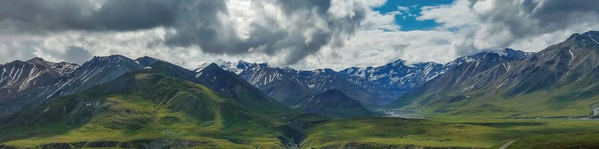 A mountainous landscape with a valley and a river.