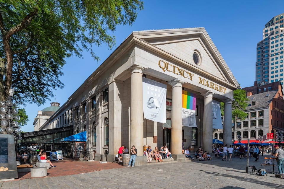 A historic building with columns and a large sign reading "City Market".