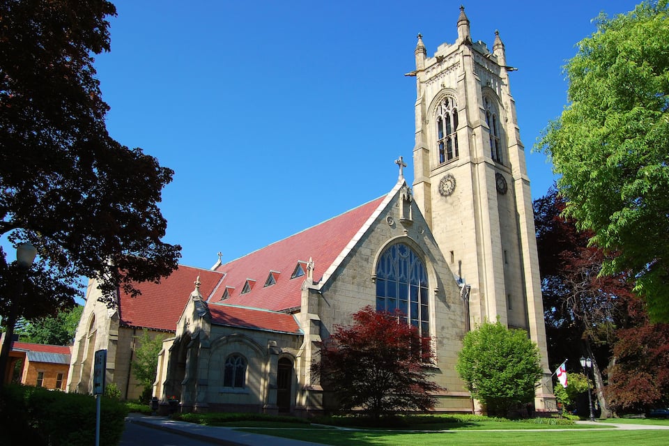 A church with a red roof and a clock tower.