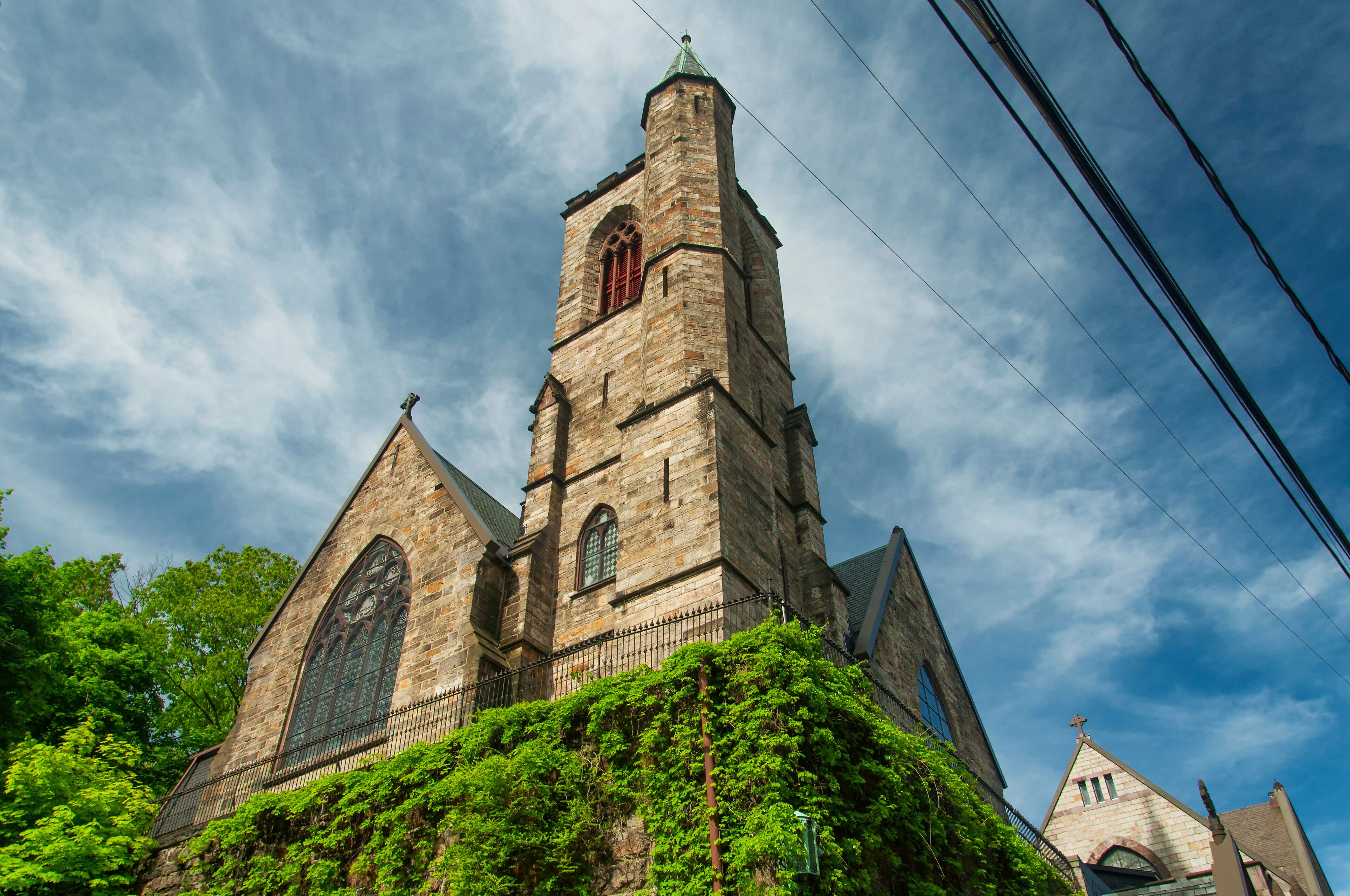 A historic church with a tall tower and arched windows.
