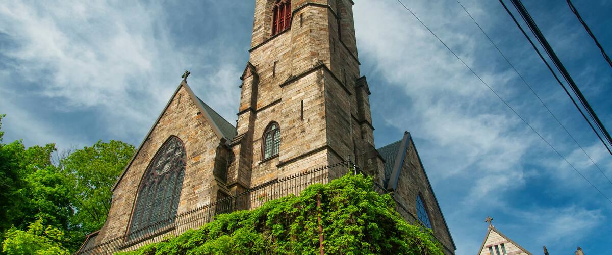 A historic church with a tall tower and arched windows.