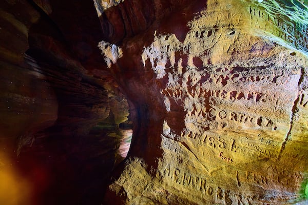 Historic Sandstone Inscriptions in Rock House Cave Eye-Level View