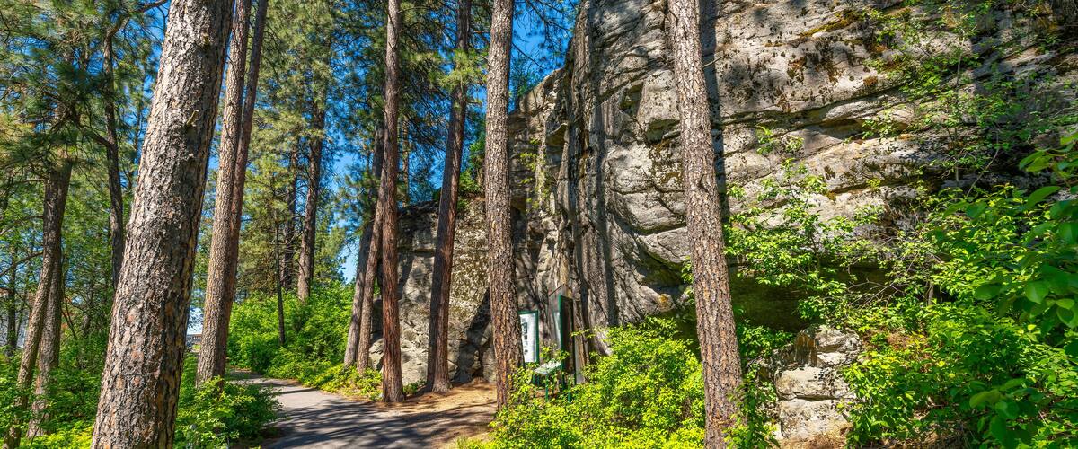 The wooded trail through the public Falls Park leading to the historic Treaty Rock a rock wall with a painted written compact between Frederick Post, a settler, and the Native American tribes in 1871.