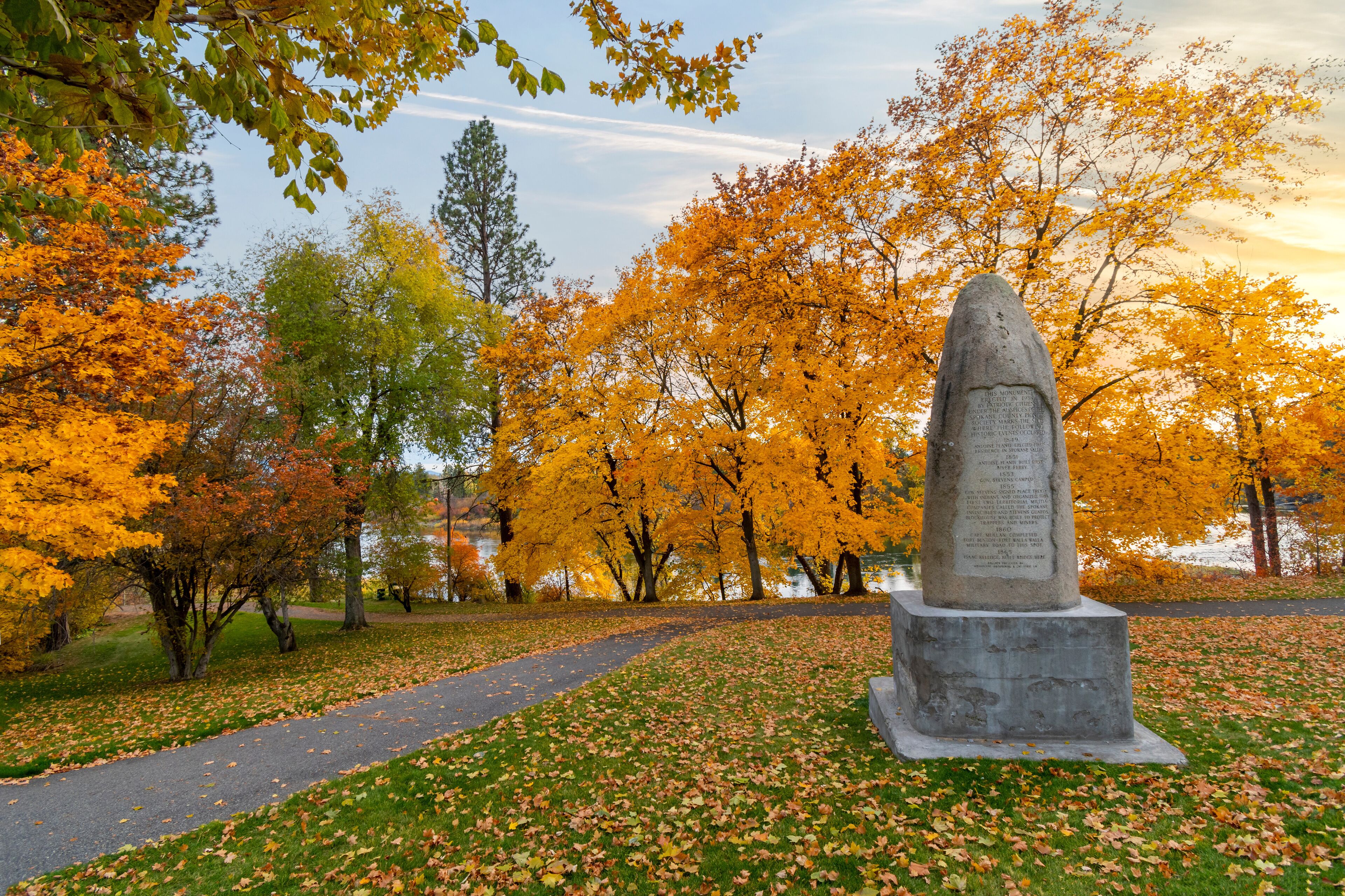 Late afternoon at Plantes Ferry park along the Spokane River with the monument to early settlers in view in Spokane, Washington, USA.