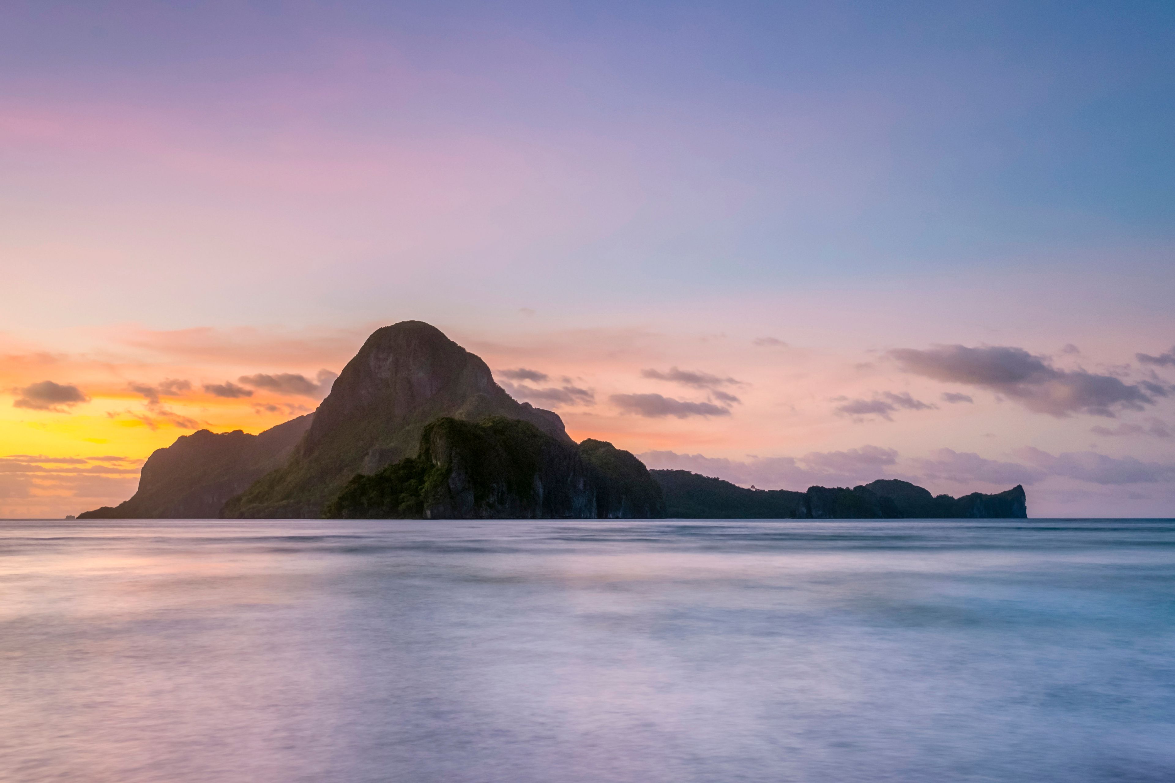 Long exposure of Cadlao Island on Bacuit Bay at sunset seen from Caalan Beach, El Nido, Palawan, Philippines