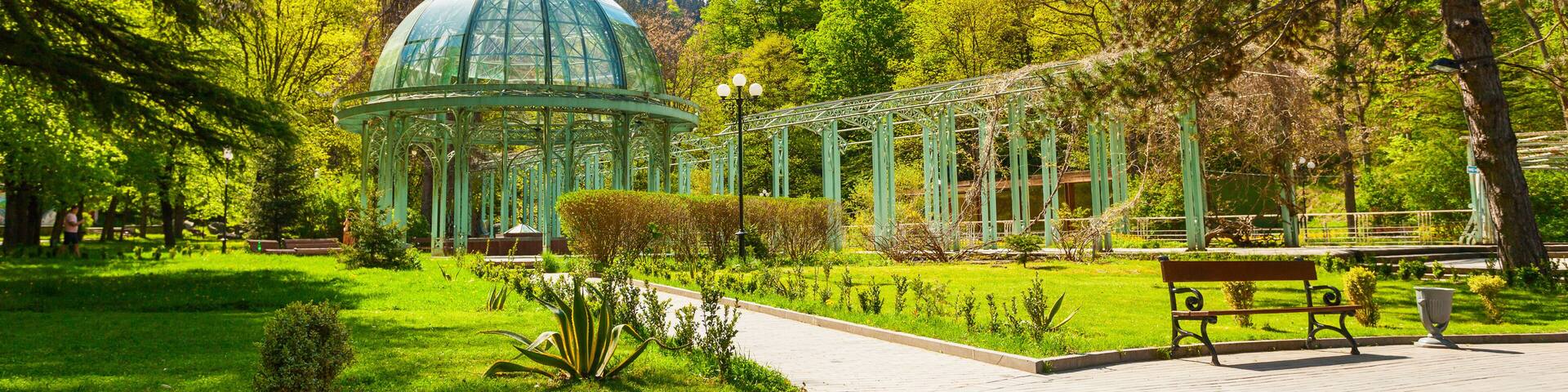Borjomi Central Historical Park. Georgia. Source with healing mineral water. Beautiful pavilion with a glass dome.