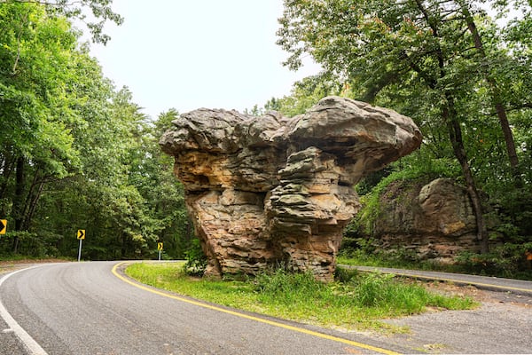 Looking east to west, Mushroom Rock appears to be two mushrooms clustered together. The national landmark sits at the center of the road on the Little River Canyon Rim Parkway in Alabama.